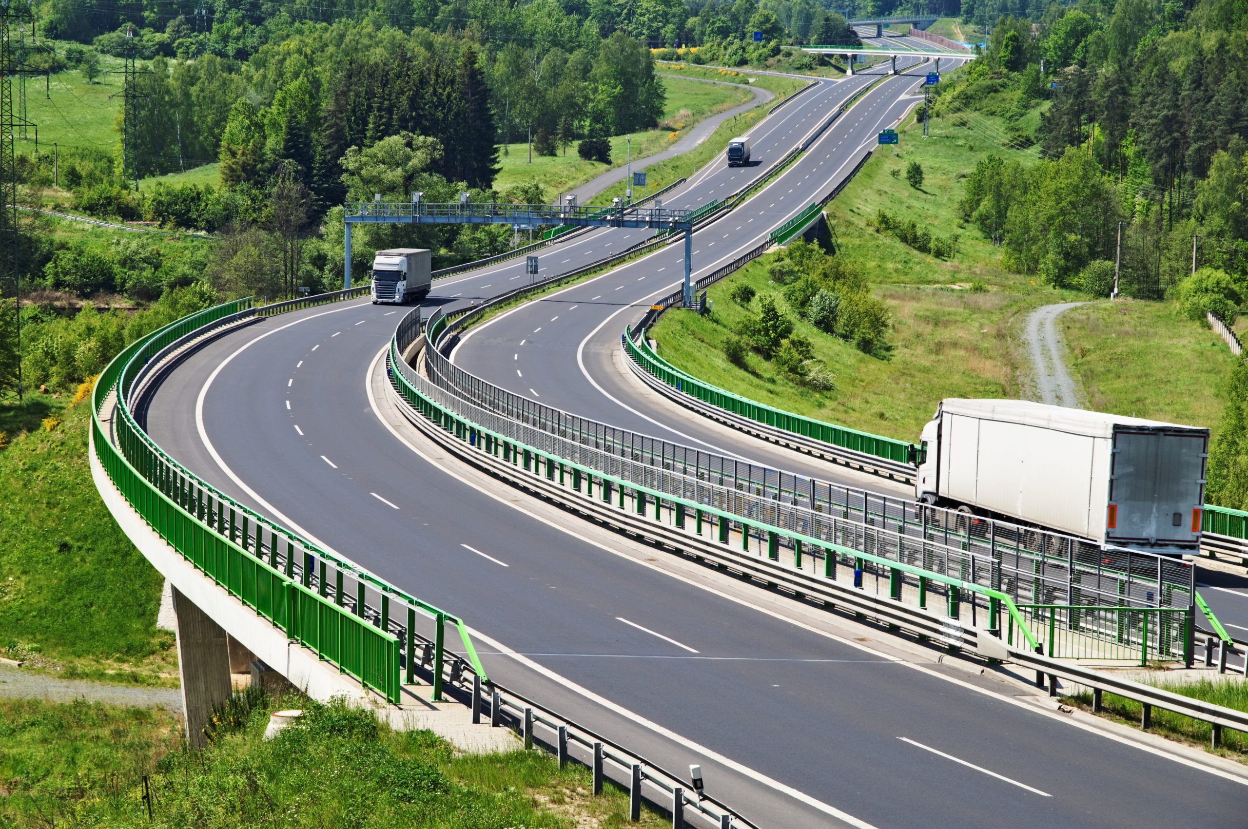 The highway between woods, electronic toll gates, three moving t
